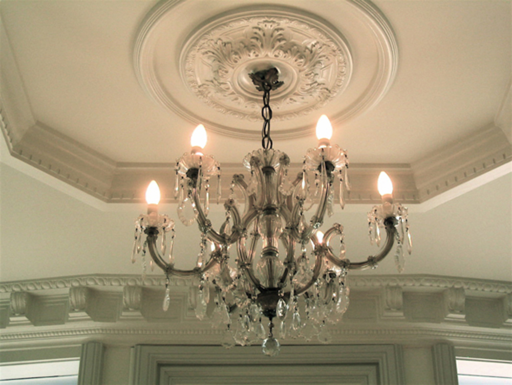 A beautifully designed modern living room with high ceilings, showcasing potential for plastercraft work.