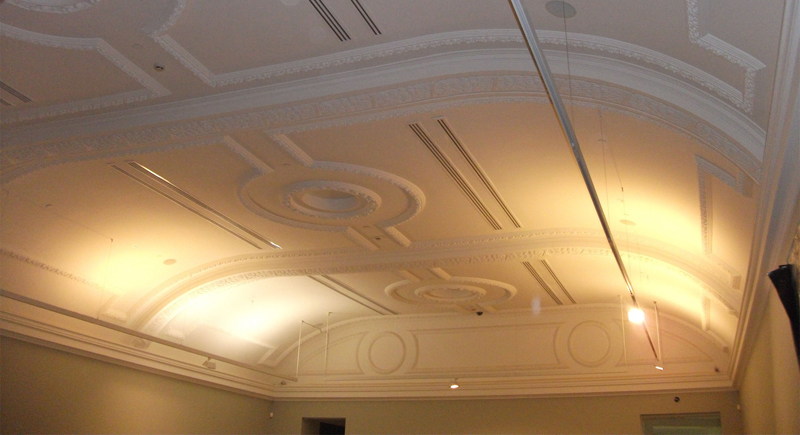 Two architects discussing blueprints in a modern office