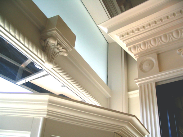 A skilled artisan carefully crafting a detailed plaster moulding